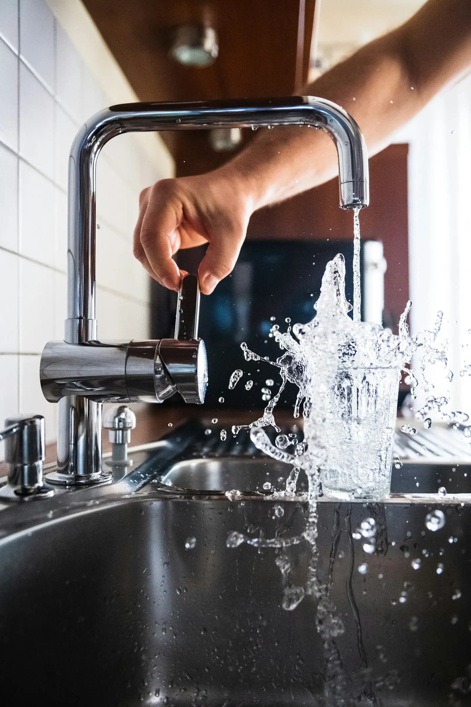 Water running from a kitchen faucet in a family home
